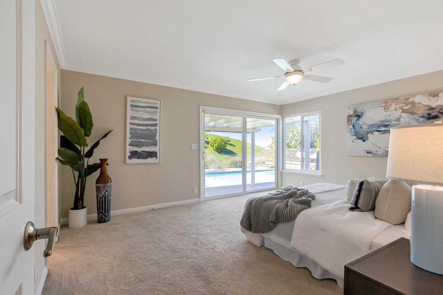 Utopia Place San Jose, CA 95127 - Photo 13 of 35 a bed room with a bed and a chandelier