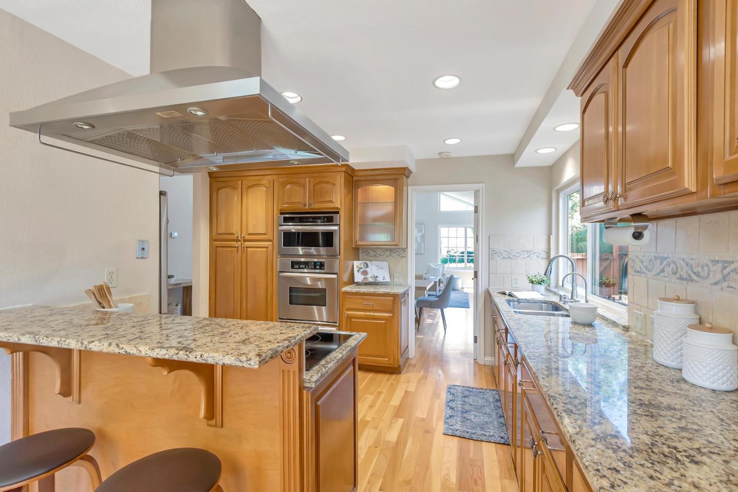 Utopia Place San Jose, CA 95127 - Photo 10 of 35 a kitchen with granite countertop a stove and a wooden floors
