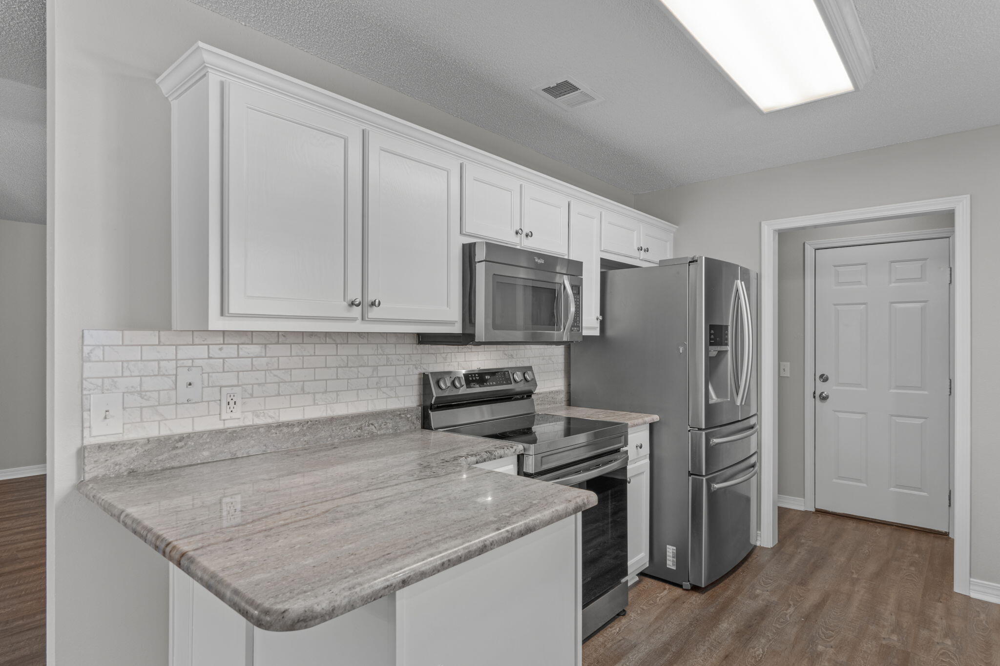 8134 Menorca Street Navarre, FL 32566 - Photo 13 of 54 a kitchen with stainless steel appliances granite countertop a sink stove and refrigerator