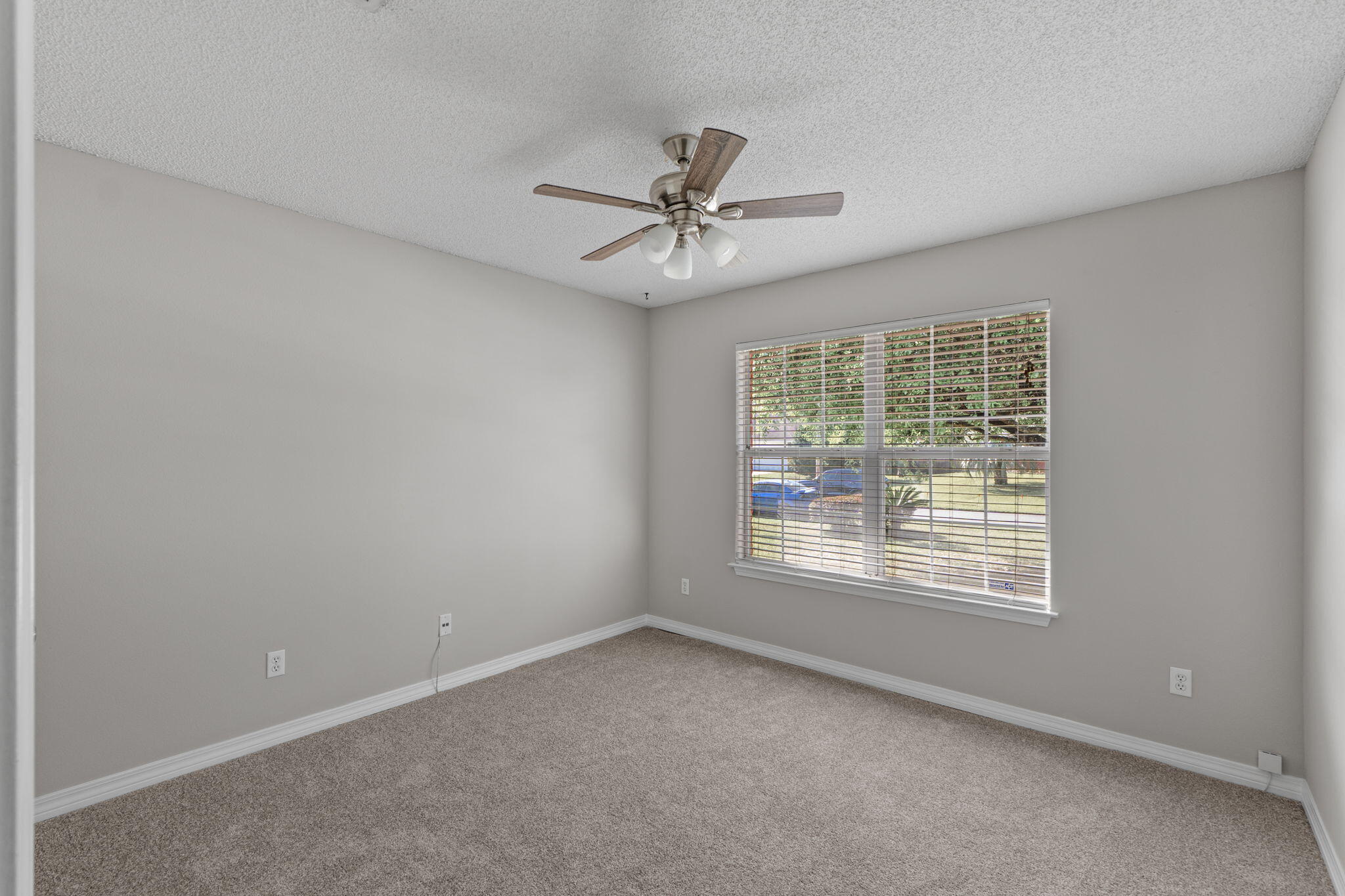 8134 Menorca Street Navarre, FL 32566 - Photo 24 of 54 an empty room with a window and a fan