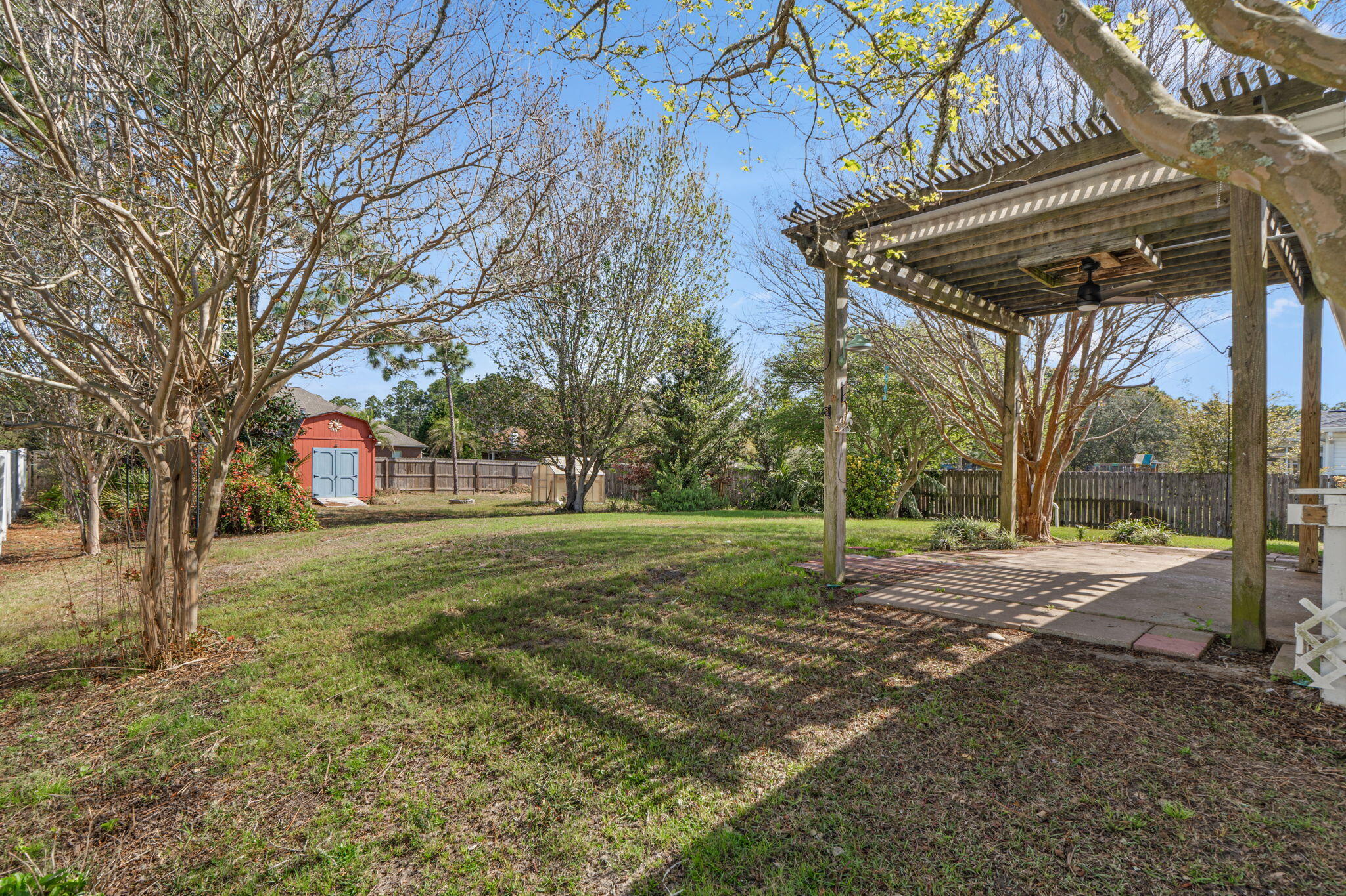 8134 Menorca Street Navarre, FL 32566 - Photo 32 of 54 a view of a yard with a house and trees