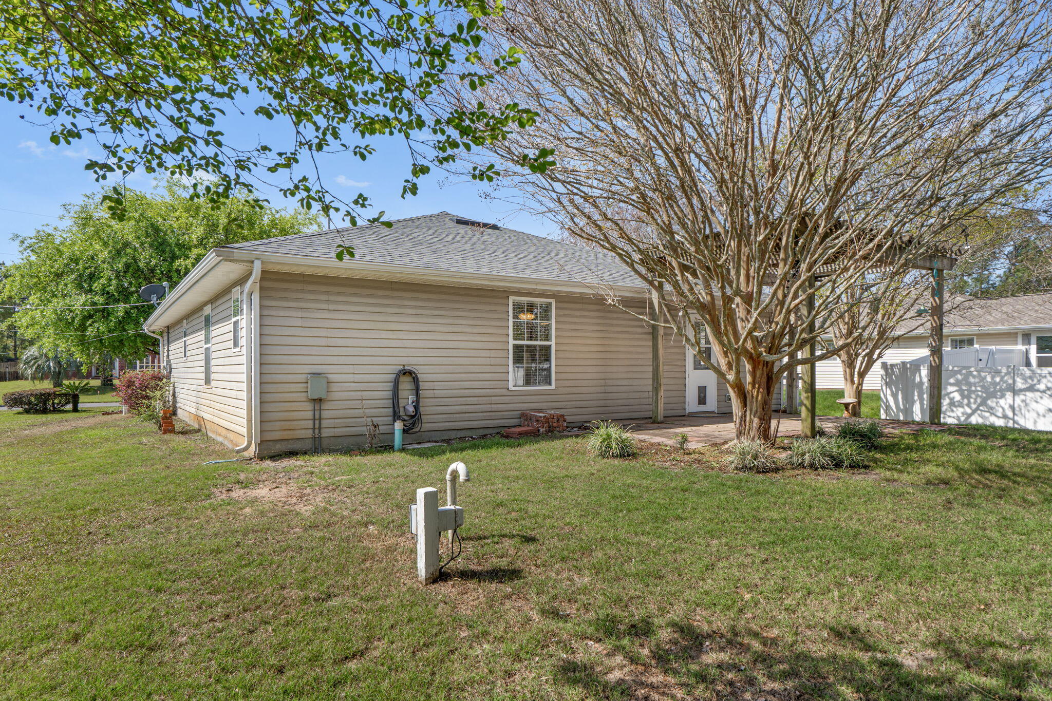 8134 Menorca Street Navarre, FL 32566 - Photo 34 of 54 a view of a house with yard and a tree