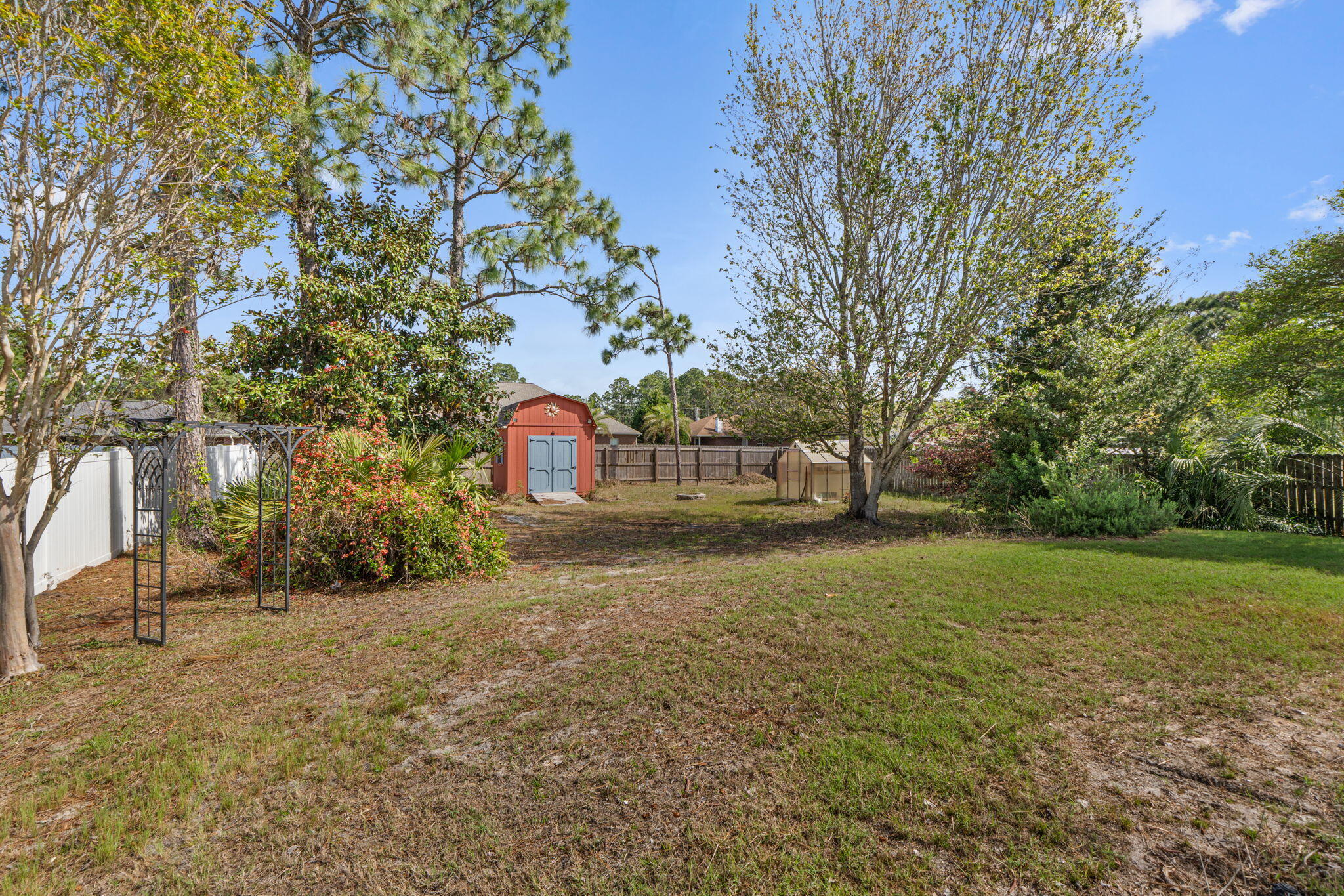 8134 Menorca Street Navarre, FL 32566 - Photo 37 of 54 a view of a yard with a tree