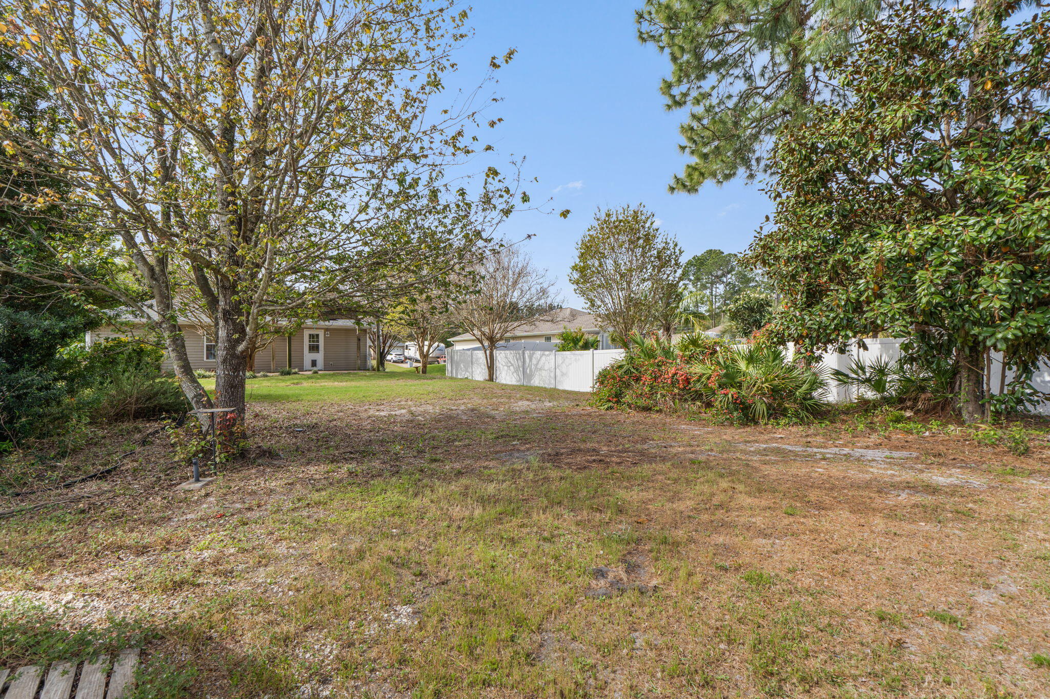 8134 Menorca Street Navarre, FL 32566 - Photo 40 of 54 a view of an house with backyard space and garden