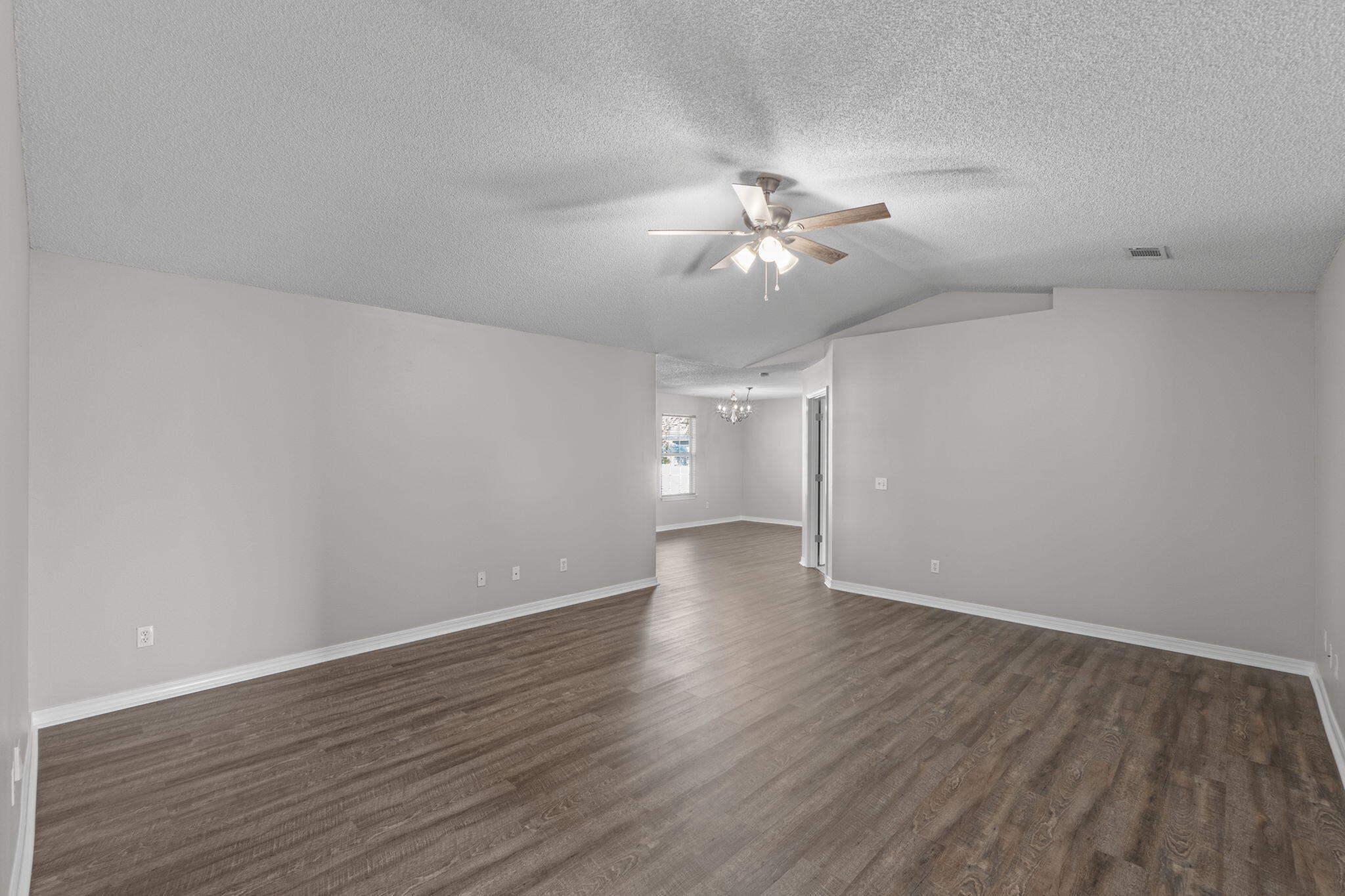 8134 Menorca Street Navarre, FL 32566 - Photo 7 of 54 a view of an empty room with wooden floor