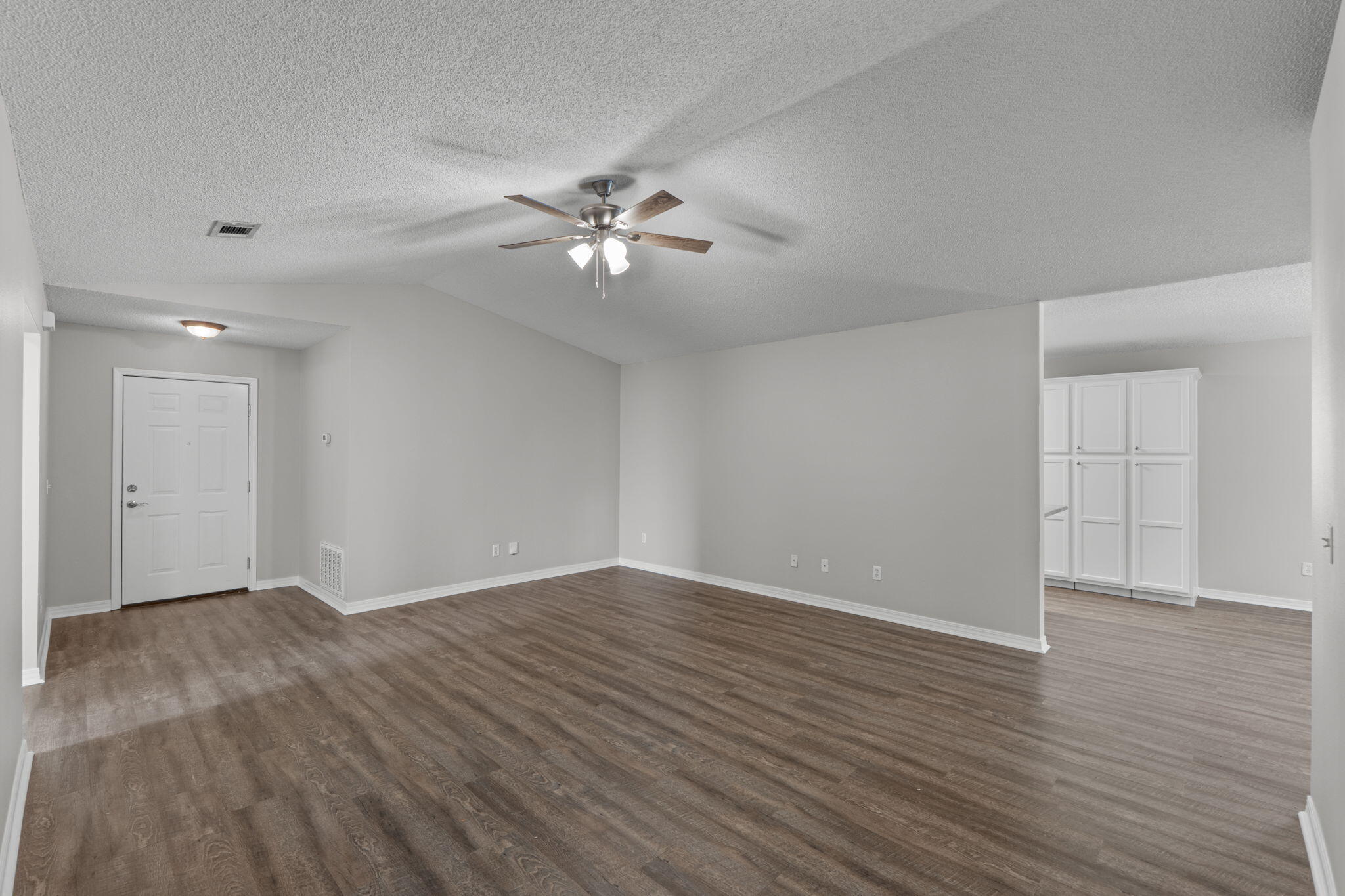 8134 Menorca Street Navarre, FL 32566 - Photo 9 of 54 a view of empty room with wooden floor