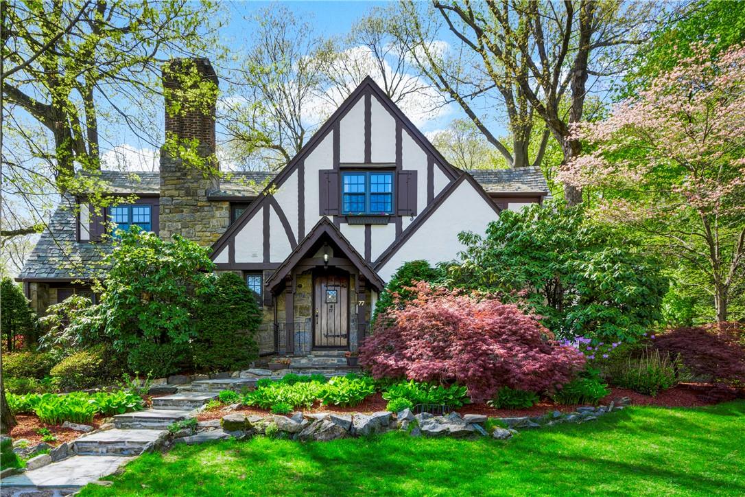 a front view of a house with garden