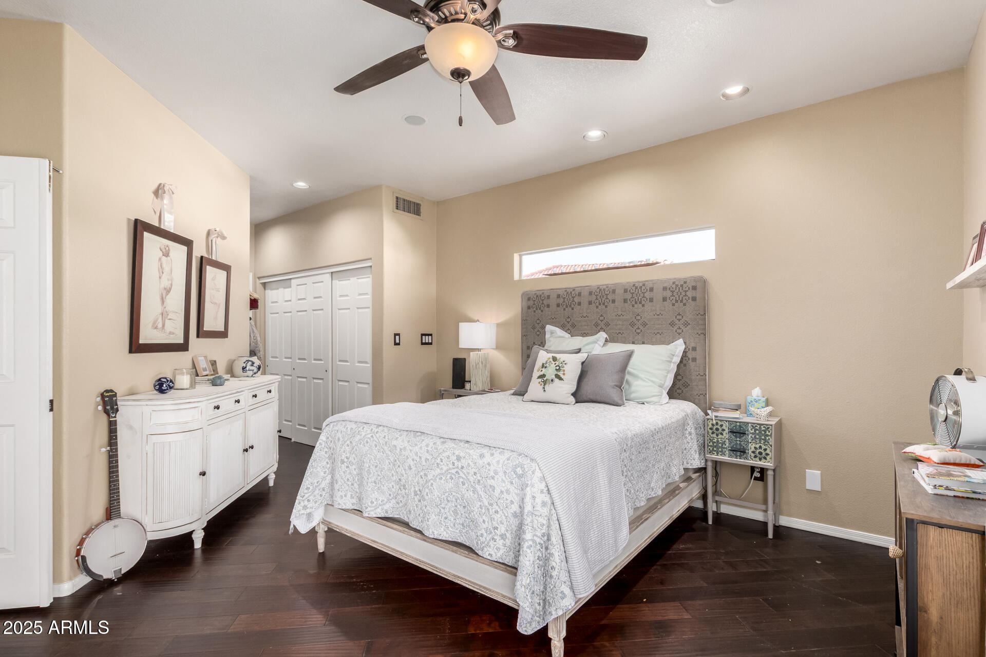 8818 South 51st Street, Unit 1 Phoenix, AZ 85044 - Photo 12 of 26 a bedroom with a bed and a chandelier