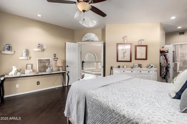 a bedroom with a bed and ceiling fan