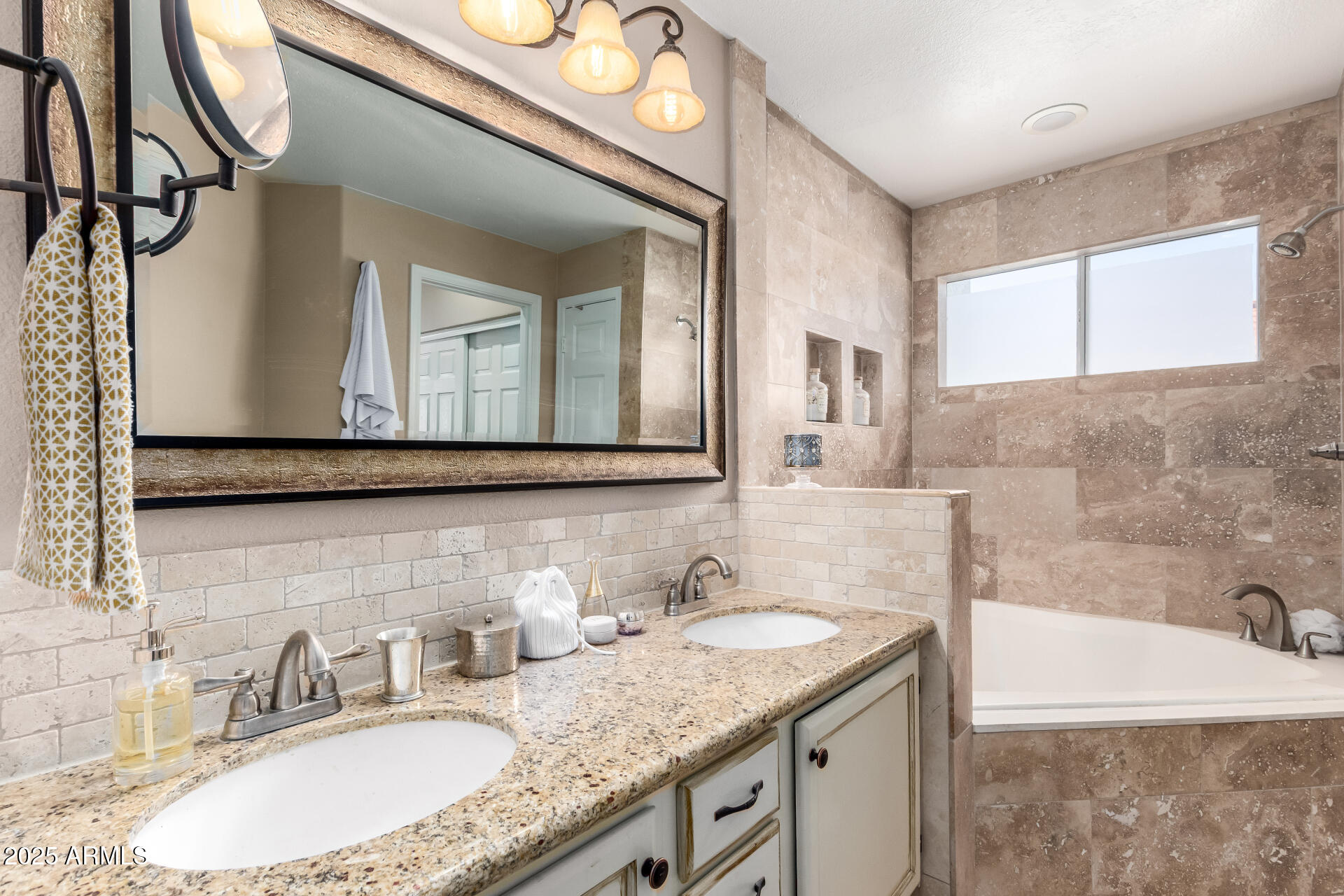 8818 South 51st Street, Unit 1 Phoenix, AZ 85044 - Photo 15 of 26 a bathroom with a granite countertop bathtub a sink and a mirror