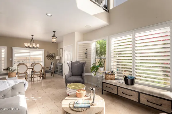 a living room with furniture and floor to ceiling windows