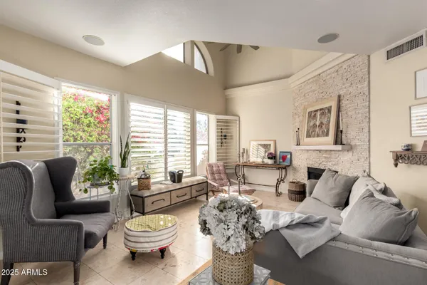a living room with furniture a large window and a dining table
