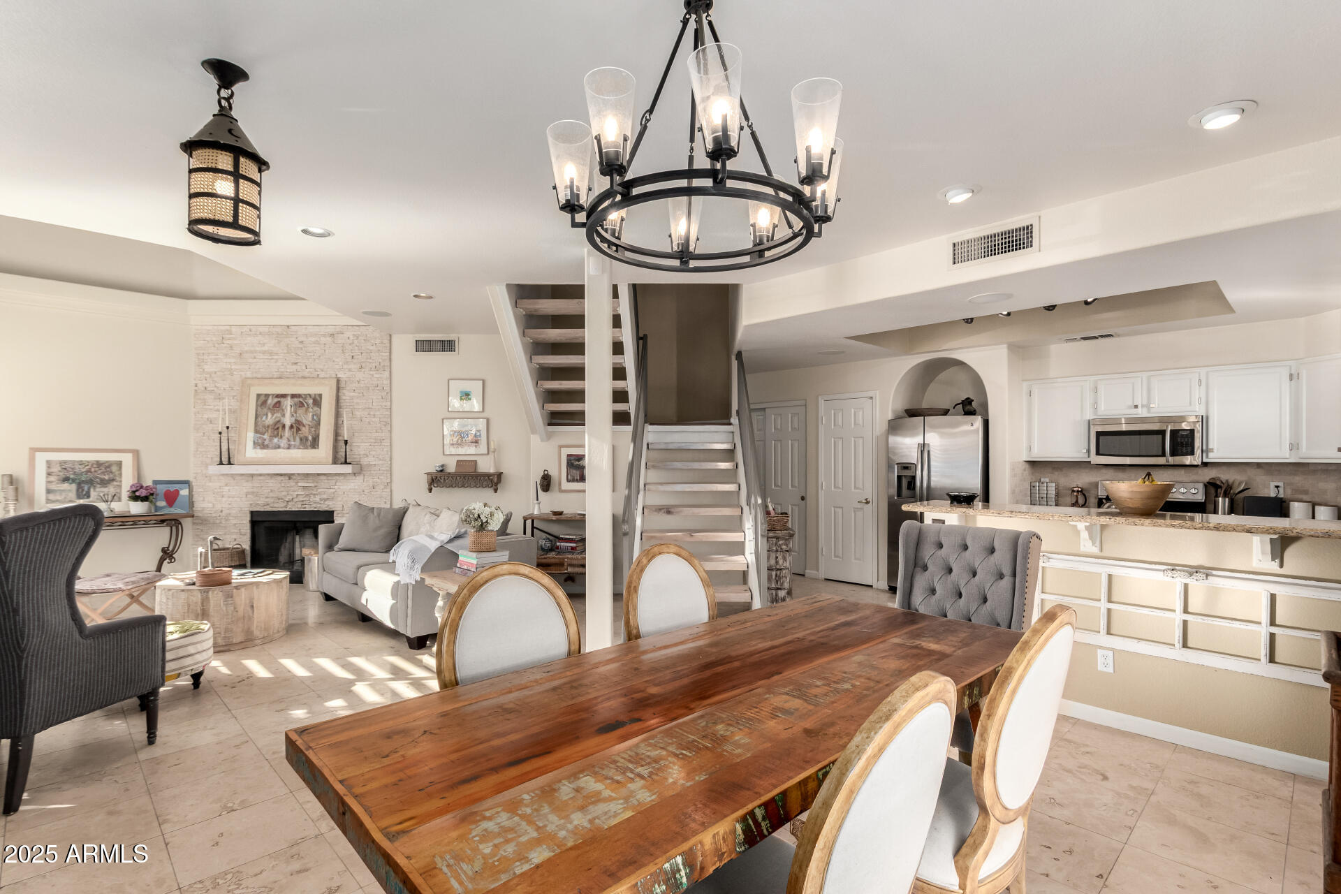 8818 South 51st Street, Unit 1 Phoenix, AZ 85044 - Photo 5 of 26 a living room with furniture a chandelier and a rug