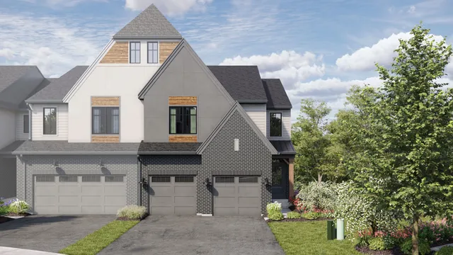 a front view of a house with a garden and plants