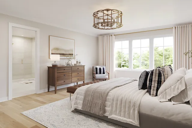 a bedroom with a large bed and a chandelier