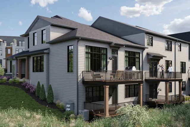 a front view of a house with plants