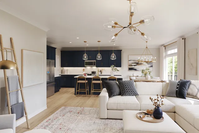 a living room with furniture kitchen view and a chandelier