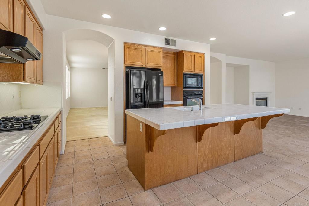 564 Echo Lane San Marcos, CA 92078 - Photo 12 of 27 a kitchen with stainless steel appliances granite countertop a sink and a stove