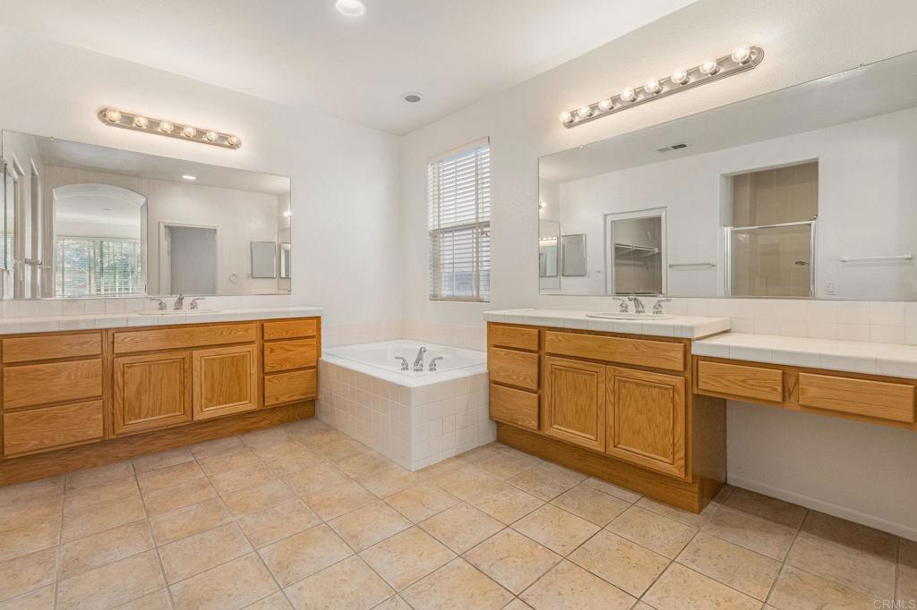 564 Echo Lane San Marcos, CA 92078 - Photo 22 of 27 a bathroom with a double vanity sink mirror and bathtub