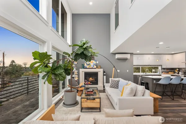 a living room with furniture a fireplace and a potted plant