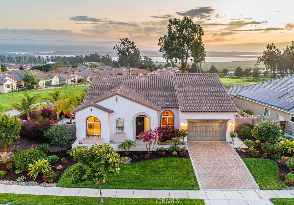 a aerial view of a house with a yard and lake view