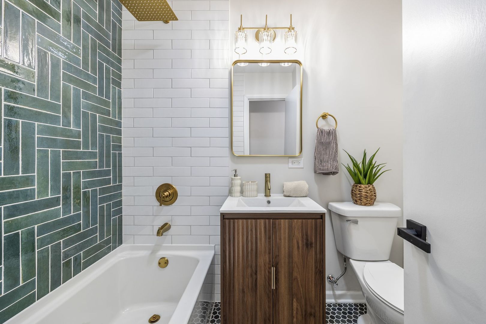 6791 Church Street Hanover Park, IL 60133 - Photo 14 of 24 a bathroom with a sink a toilet and shower