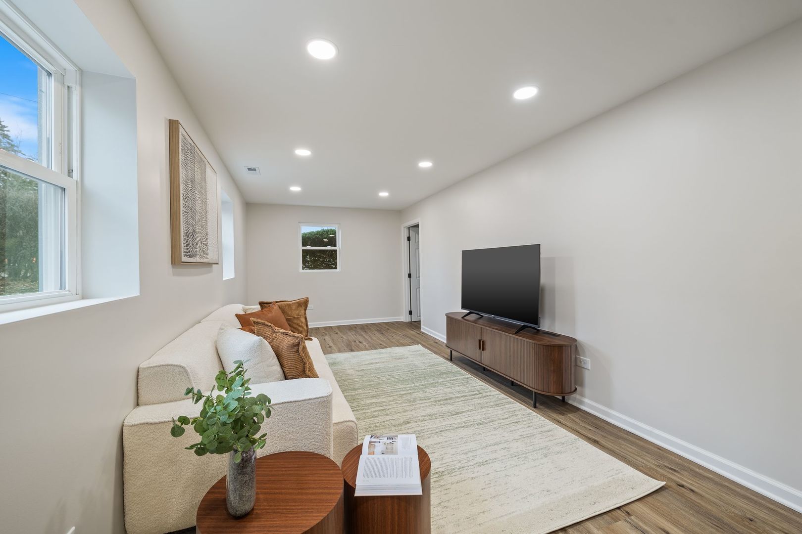 6791 Church Street Hanover Park, IL 60133 - Photo 16 of 24 a living room with furniture and a flat screen tv
