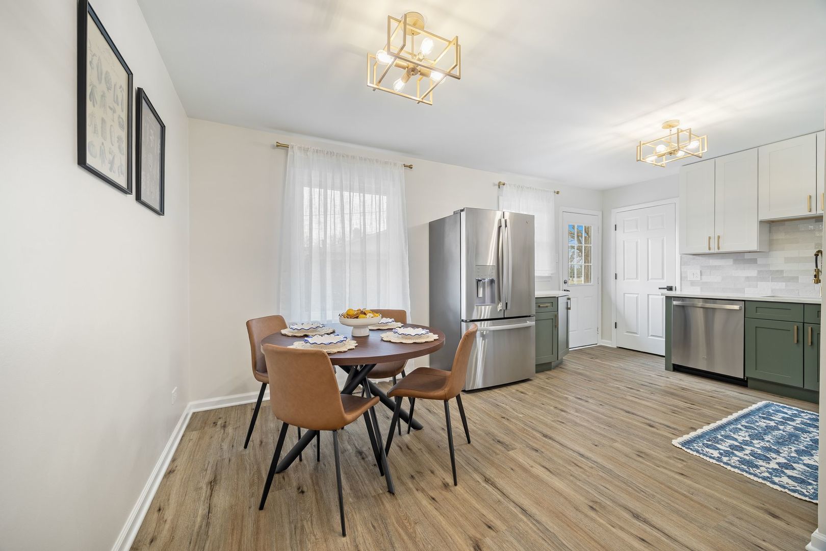 6791 Church Street Hanover Park, IL 60133 - Photo 4 of 24 a kitchen with stainless steel appliances wooden floor and a refrigerator