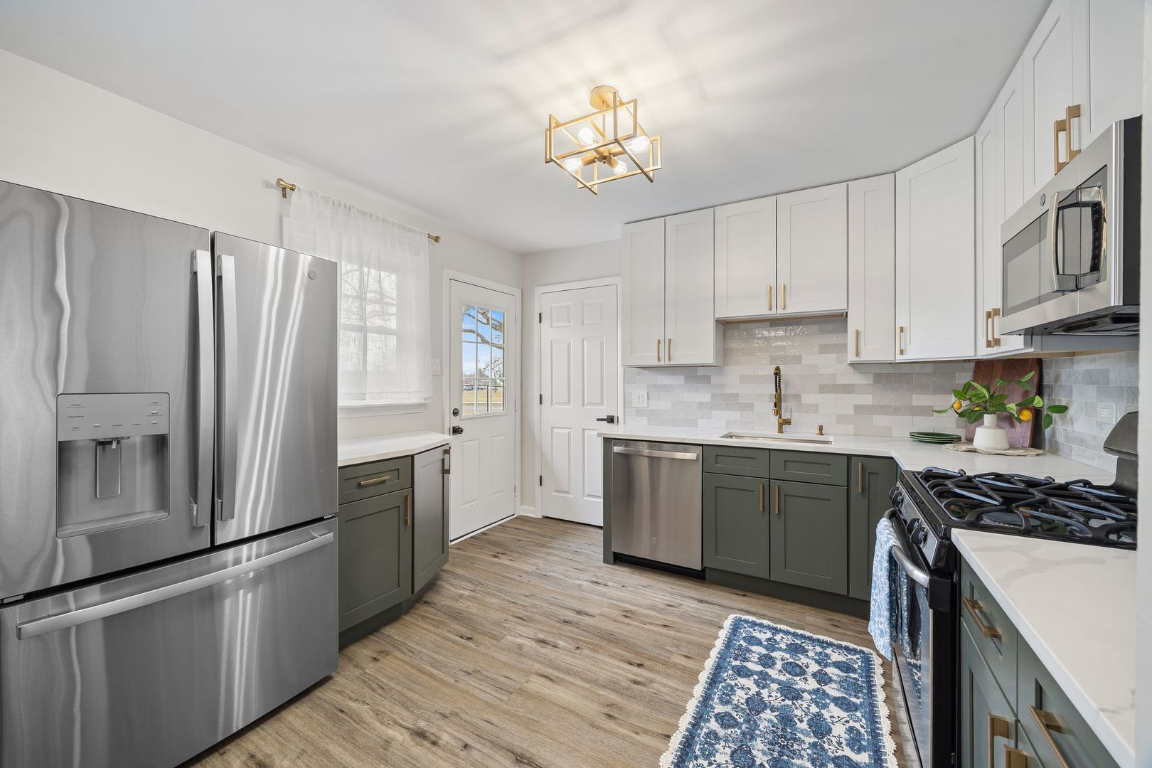 6791 Church Street Hanover Park, IL 60133 - Photo 5 of 24 a kitchen with stainless steel appliances a refrigerator sink and cabinets