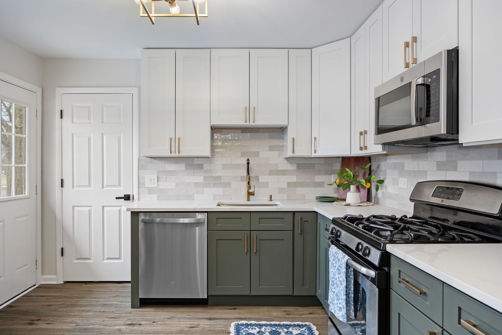 6791 Church Street Hanover Park, IL 60133 - Photo 6 of 24 a kitchen with stainless steel appliances granite countertop a sink stove and microwave