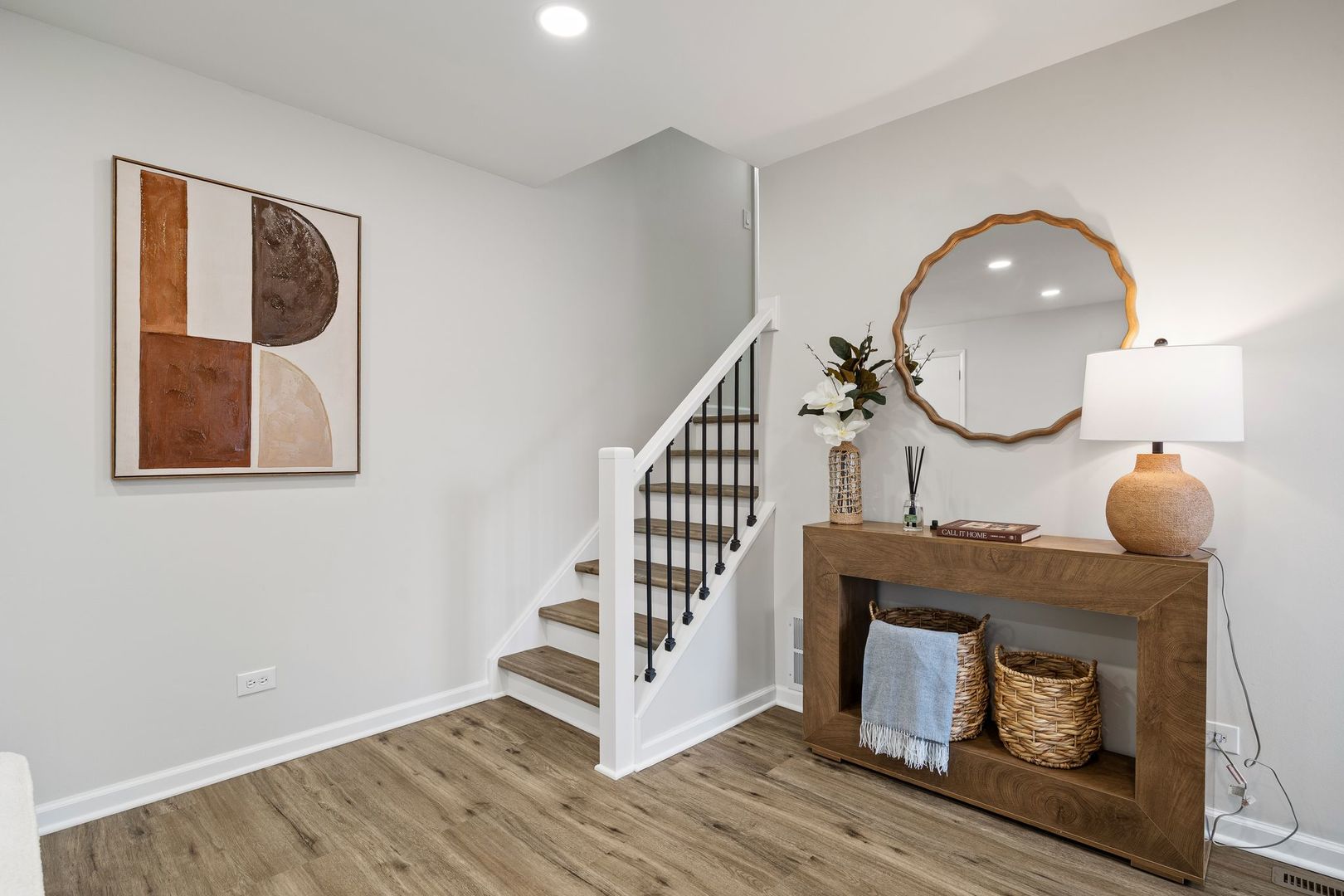 6791 Church Street Hanover Park, IL 60133 - Photo 8 of 24 a view of a livingroom with wooden floor and a staircase