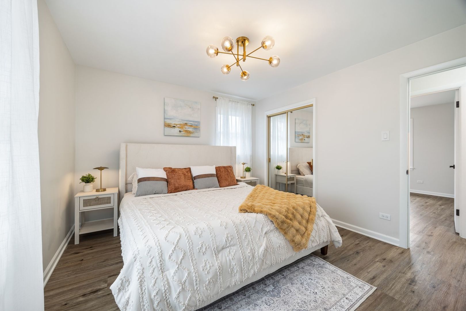 6791 Church Street Hanover Park, IL 60133 - Photo 10 of 24 a bedroom with a bed and a chandelier