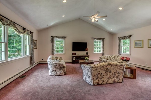 12 Ogunquit Road Wilmington, MA 01887 - Photo 12 of 27 a living room with furniture and a flat screen tv