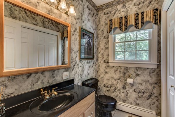 12 Ogunquit Road Wilmington, MA 01887 - Photo 15 of 27 a bathroom with a sink a toilet and a mirror