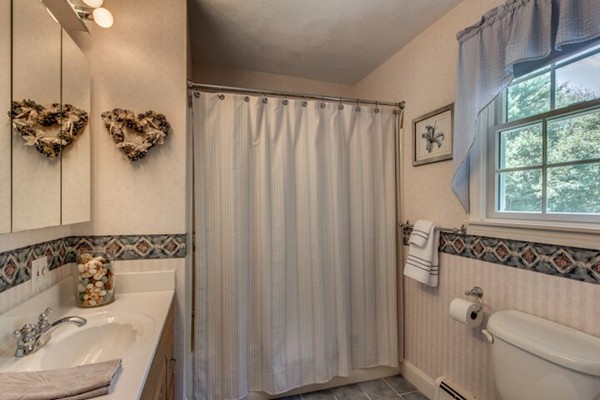 12 Ogunquit Road Wilmington, MA 01887 - Photo 22 of 27 a bathroom with a sink and mirror with toilet