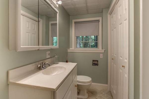 12 Ogunquit Road Wilmington, MA 01887 - Photo 25 of 27 a bathroom with a sink a toilet and a mirror