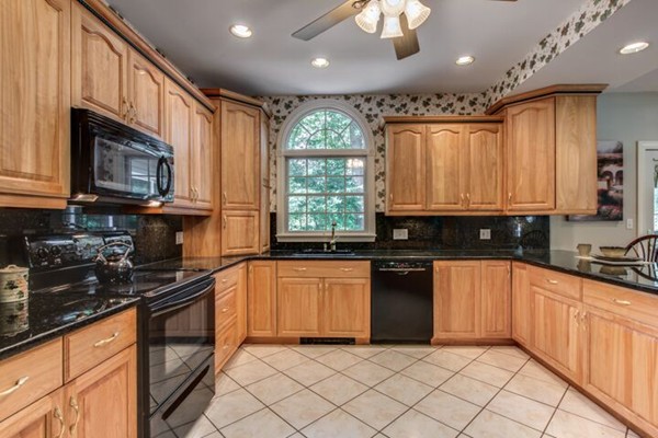 12 Ogunquit Road Wilmington, MA 01887 - Photo 7 of 27 a kitchen with stainless steel appliances granite countertop a stove a sink and a microwave