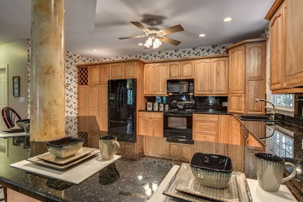 12 Ogunquit Road Wilmington, MA 01887 - Photo 9 of 27 a kitchen with a stove a sink and a refrigerator