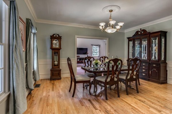 12 Ogunquit Road Wilmington, MA 01887 - Photo 10 of 27 a view of a dining room with furniture a chandelier and wooden floor