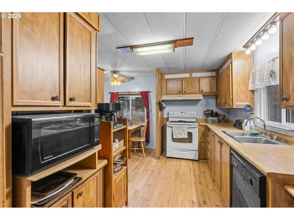 a kitchen with a stove a sink and a microwave