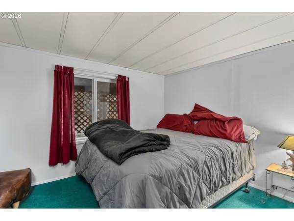 a bedroom with a bed and a night stand