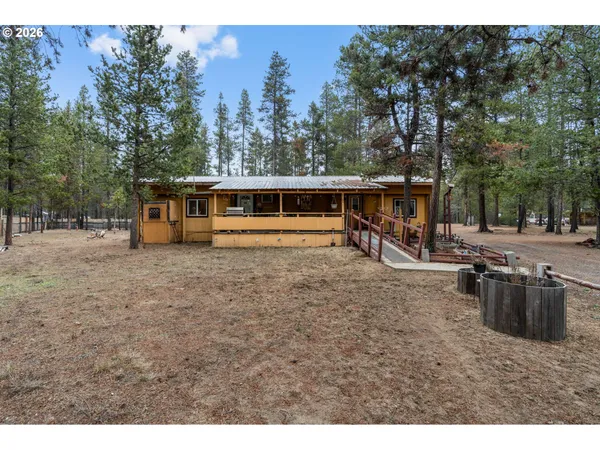 a view of a house with a backyard and a patio