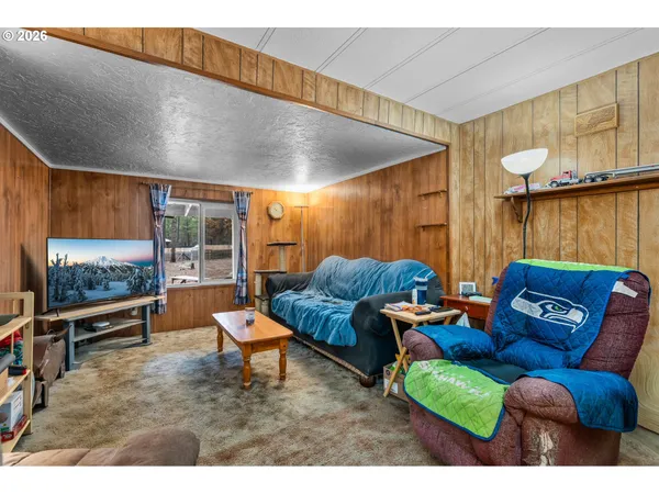 a outdoor living space with furniture and a flat screen tv