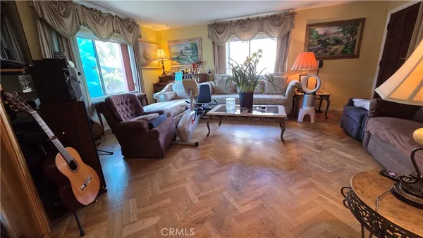 a living room with furniture a window and a flat screen tv