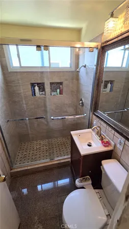 a bathroom with a sink toilet and mirror