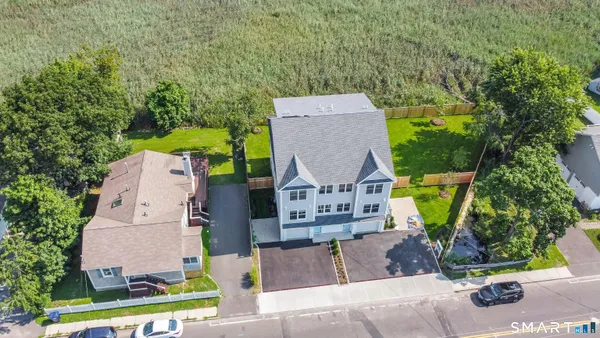 an aerial view of a house with garden space and street view