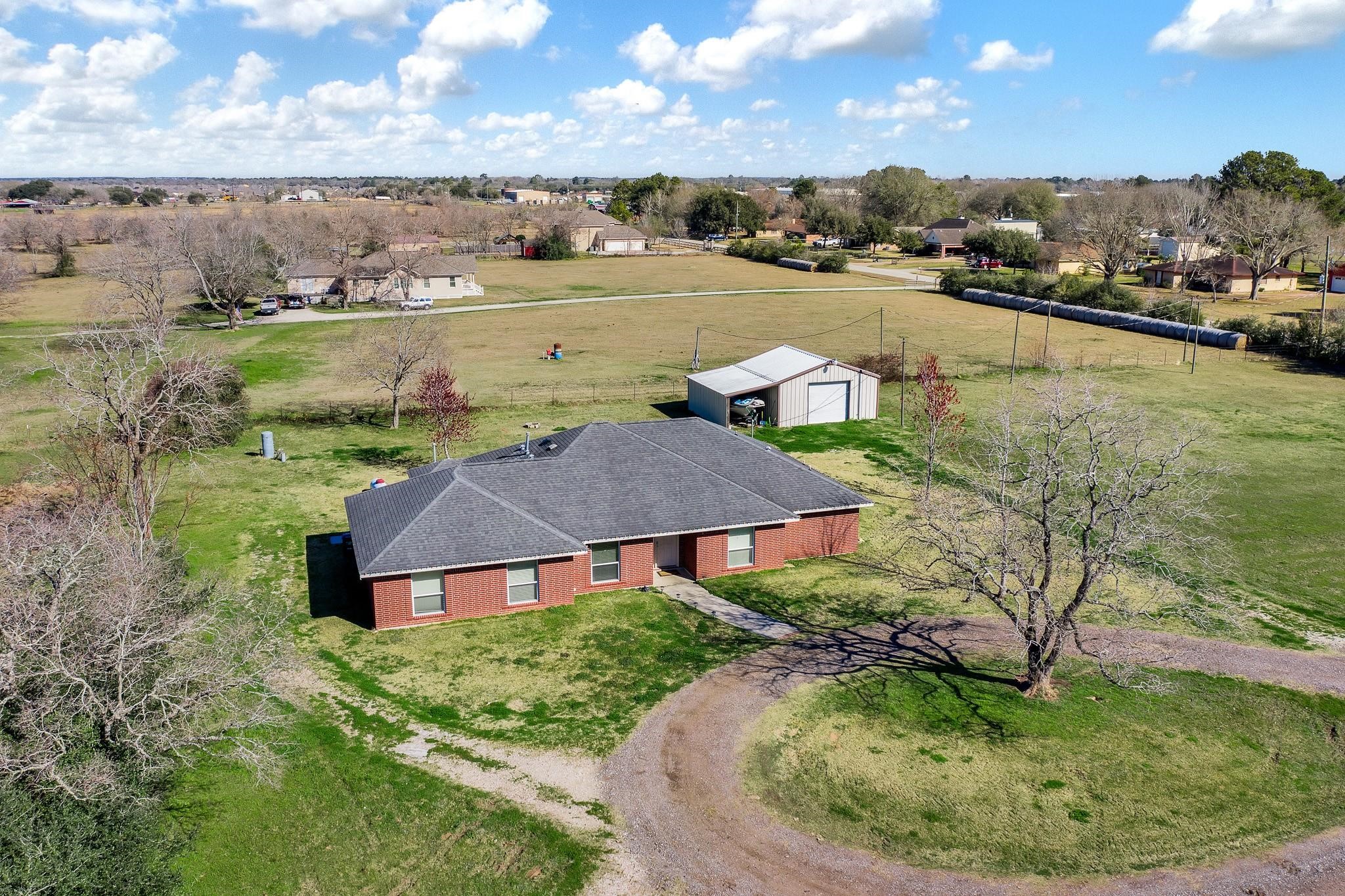 15815 Merle Road Cypress, TX 77433 - Photo 1 of 16 a view of a house with a yard and lake view