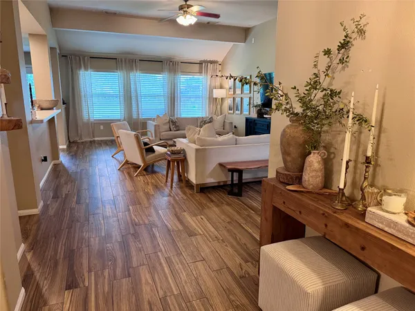 a living room with furniture and wooden floor