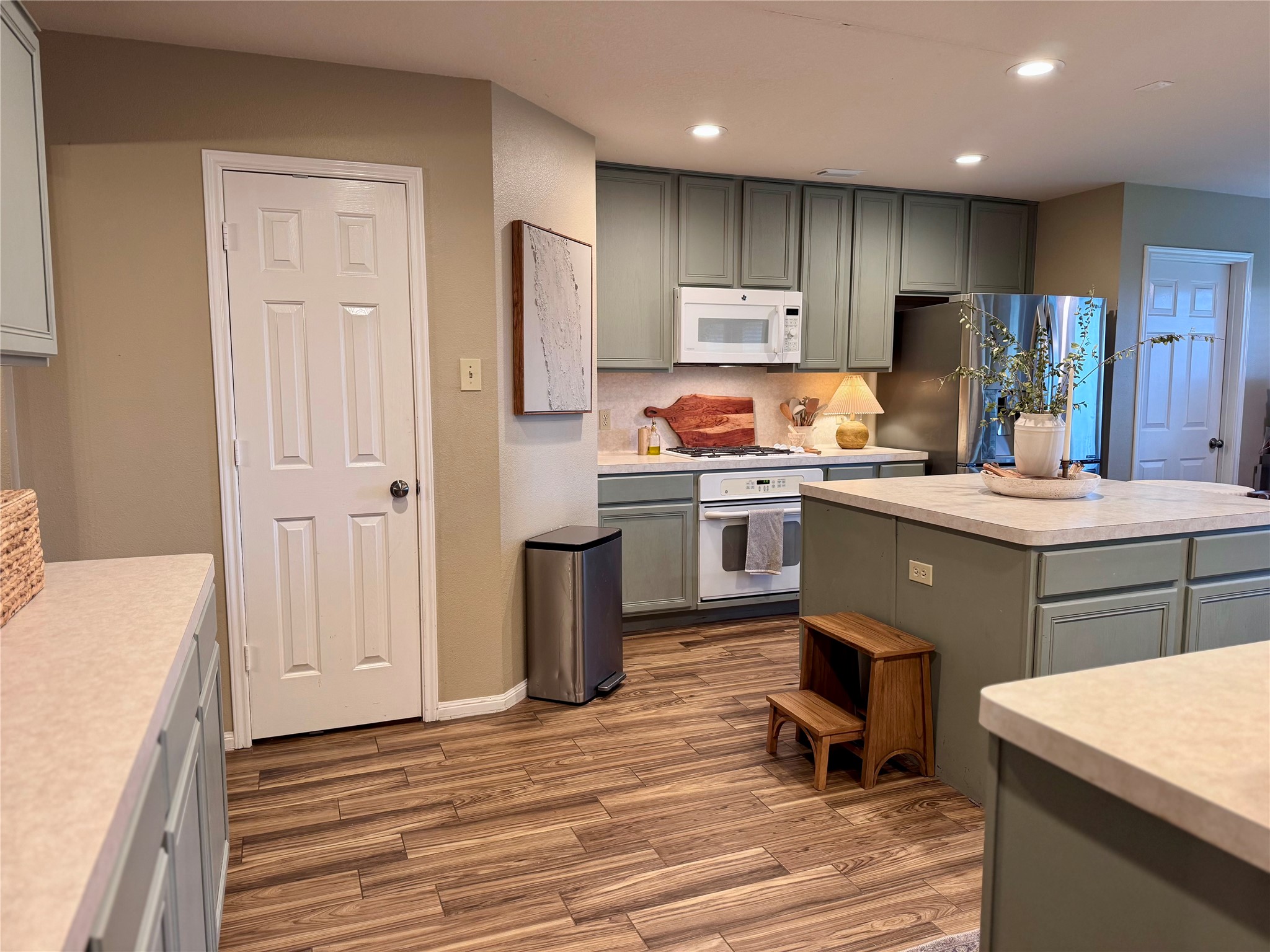 15815 Merle Road Cypress, TX 77433 - Photo 7 of 16 a kitchen with kitchen island a sink stove and refrigerator