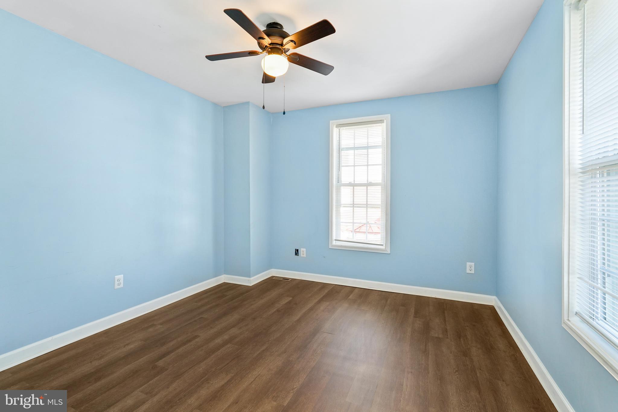 132 South Queen Street Rising Sun, MD 21911 - Photo 21 of 29 an empty room with wooden floor windows and fan